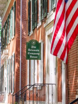 The front entrance of Delaware Corporate Headquarters, with an American Flag.